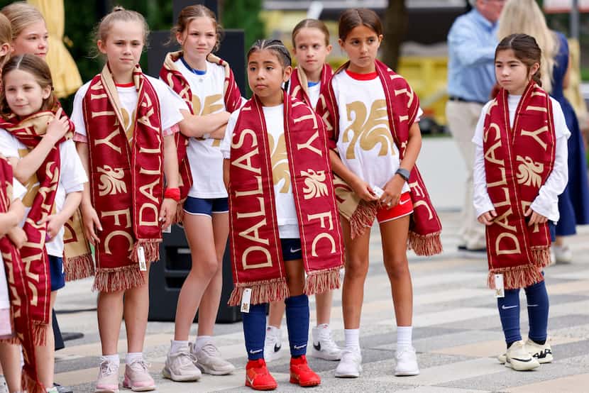 Children wear Dallas Trinity FC shirts and scarves after the name was announced for the new...