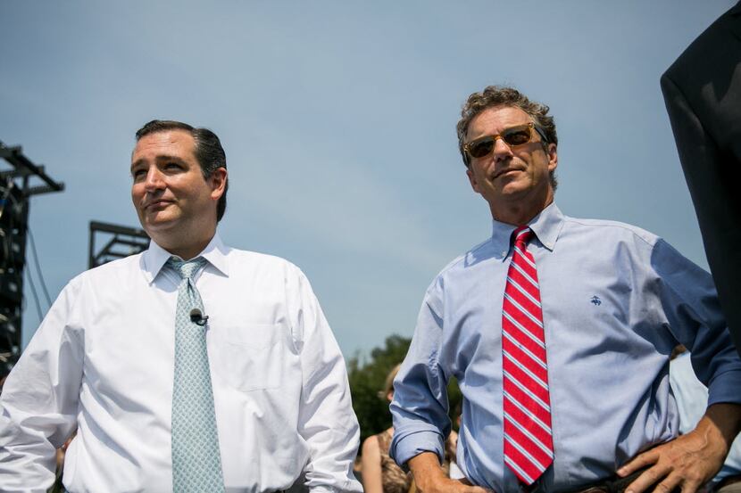 Sens. Ted Cruz of Texas and Rand Paul of Kentucky wait to speak to tea partiers Tuesday at...