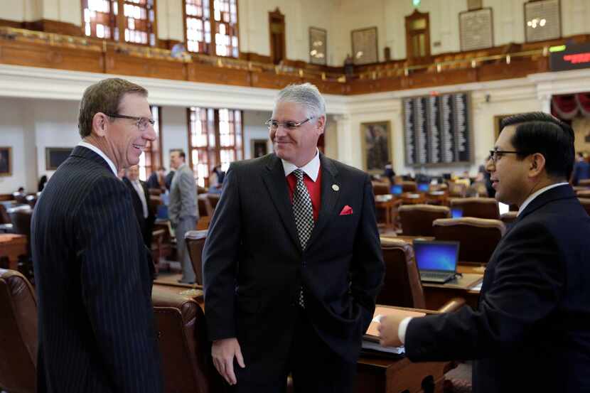 Rep. Dan Huberty, R-Houston, center, talks with Rep. Byron Cook, R-Corsicana, left, and Rep....