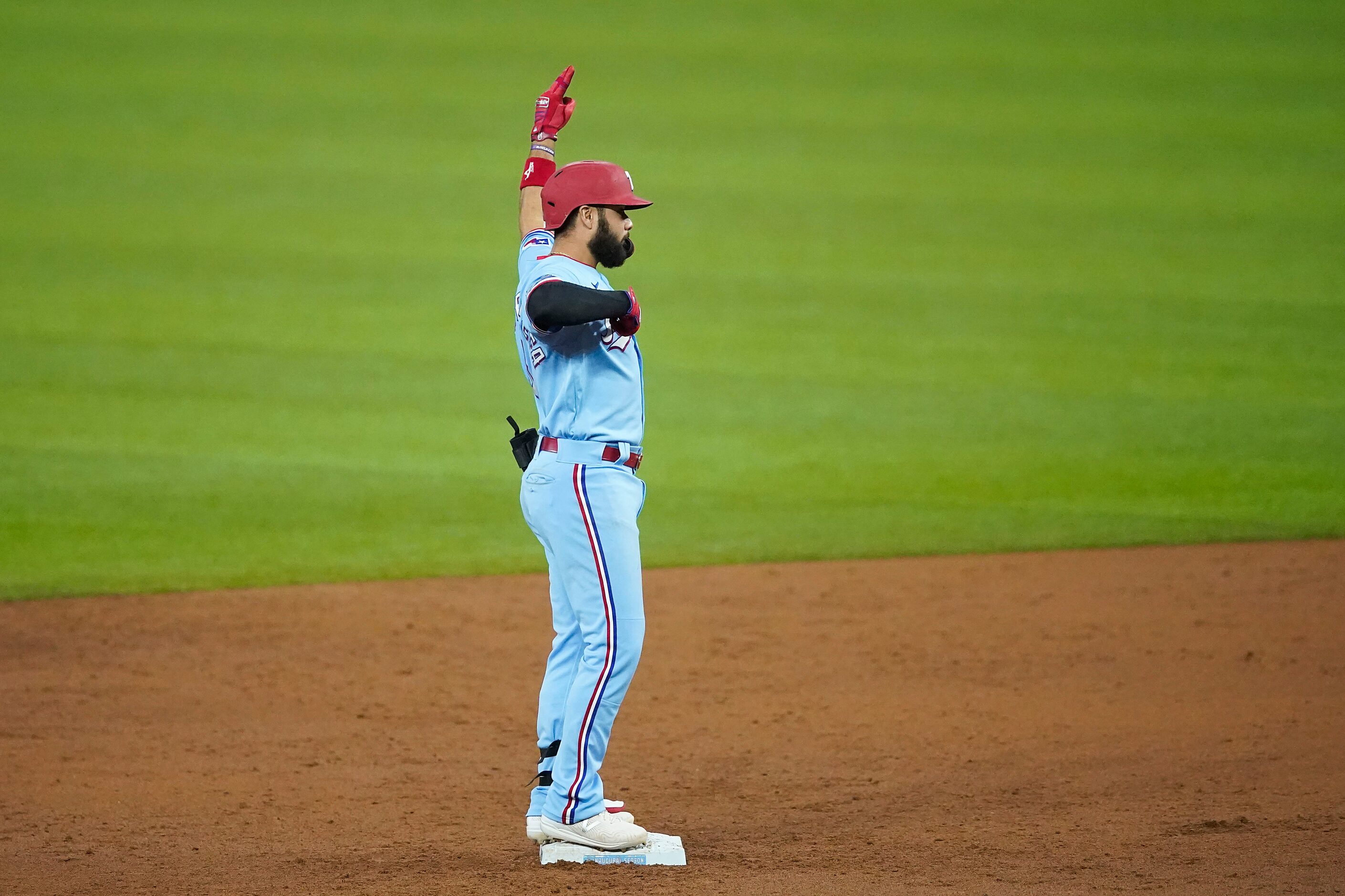 Texas Rangers third baseman Isiah Kiner-Falefa celebrates after driving in a run with a...