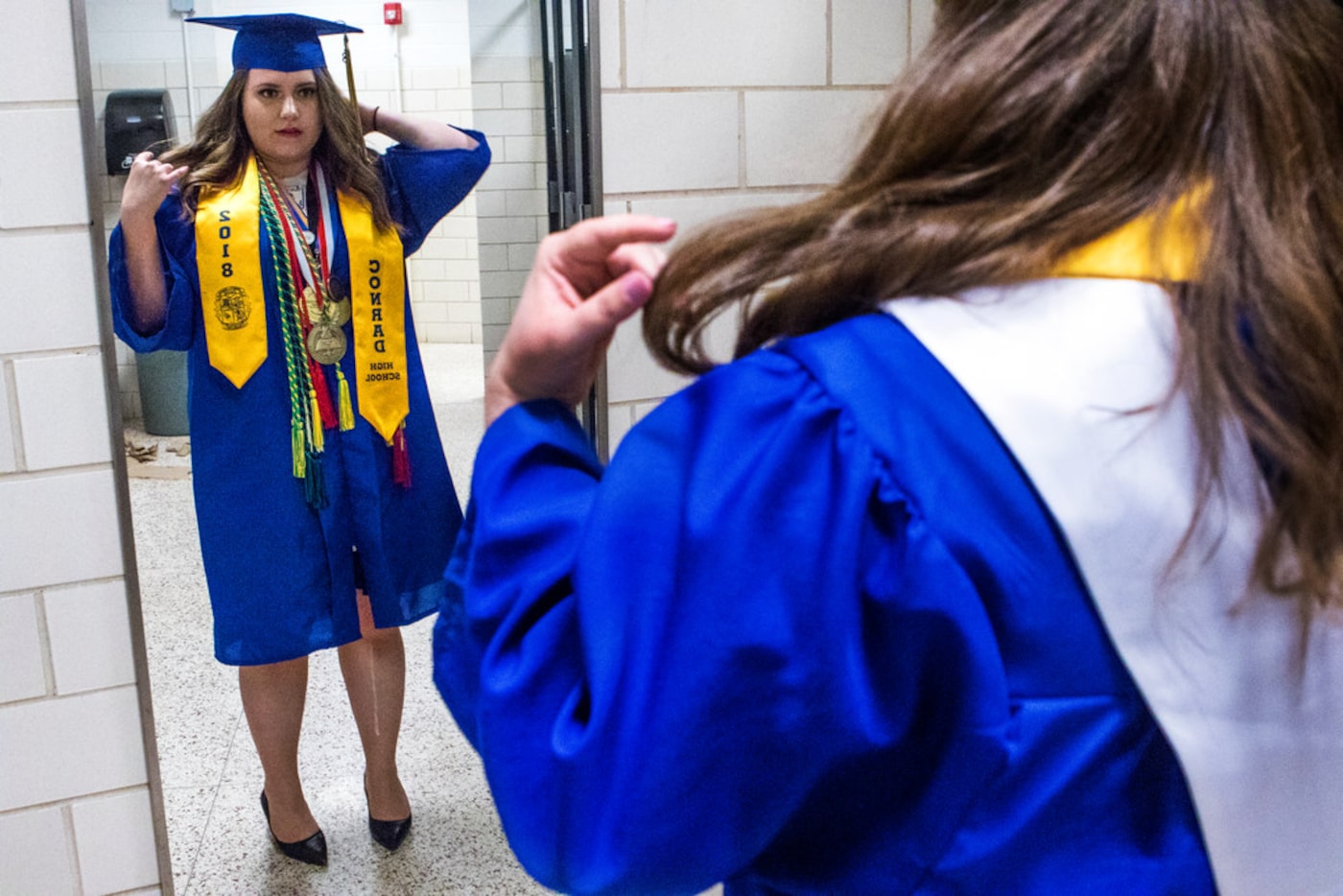 Former Emmett J. Conrad High School student Albana Gllareva makes last-minute touches to her...