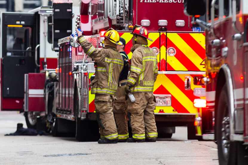 Fire fighters stand outside of Zenna Thai & Japanese Restaurant after fighting a fire that...