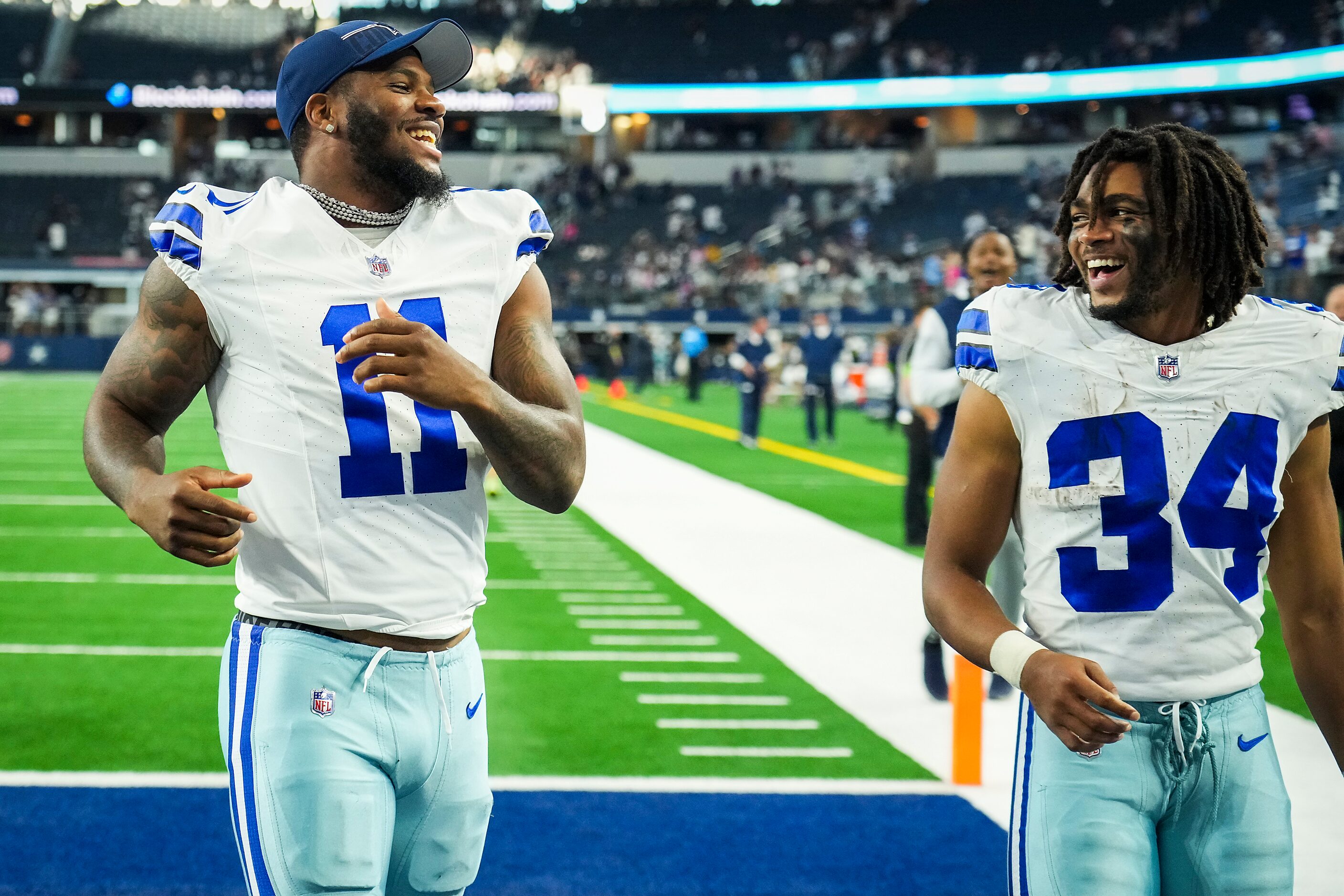 Dallas Cowboys linebacker Micah Parsons (11) laughs with running back Malik Davis (34) as...