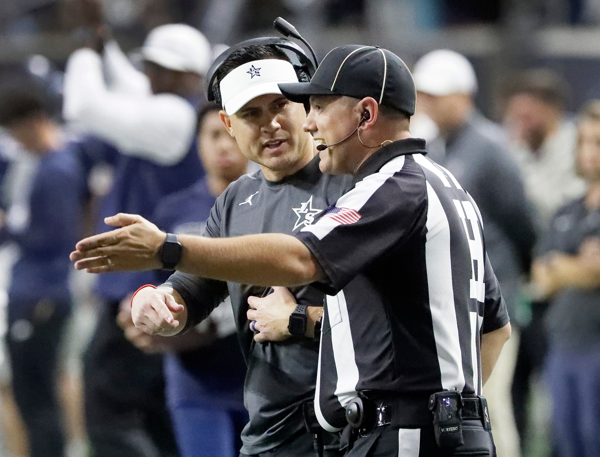 Lone Star High School head coach Jeff Rayburn questions a ref during the first half as Lone...