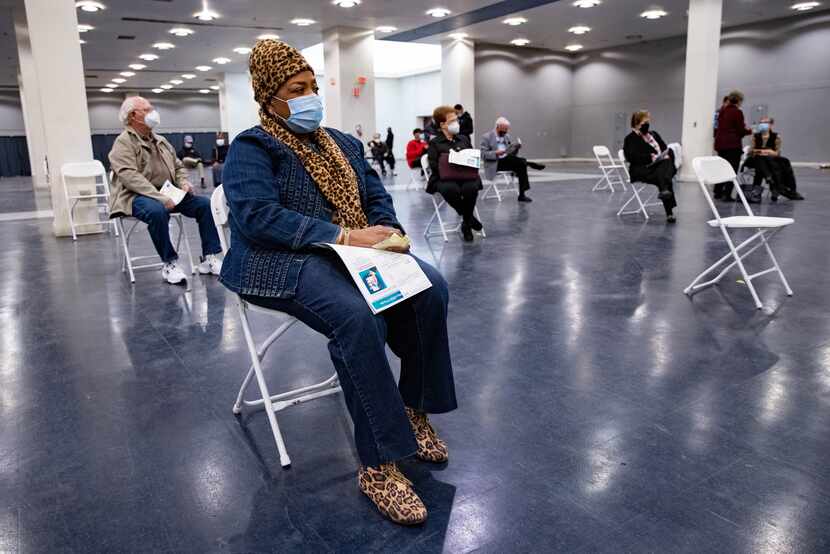 Gladys Rodgers, 77, waits after receiving the COVID-19 vaccine in the post vaccination...