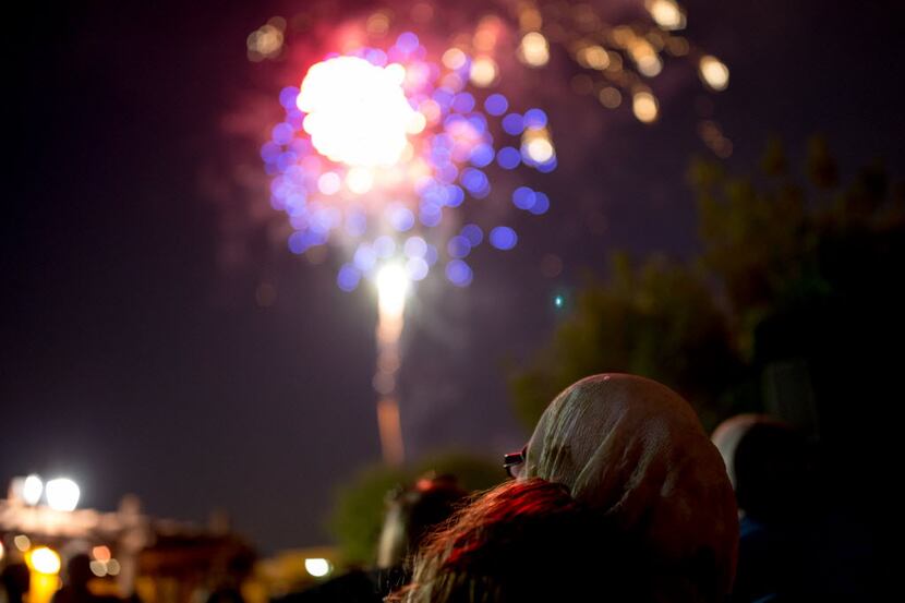 Yamna Goughbar, of Hurst, Texas, watches fireworks from Southlake Town Square in this 2016...