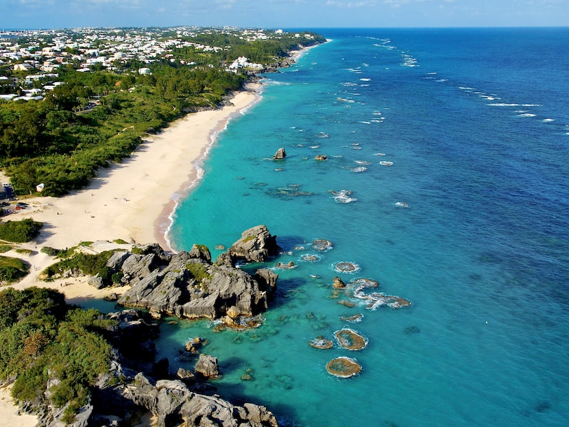 Clear teal-blue waters lap at Bermuda's coastline.