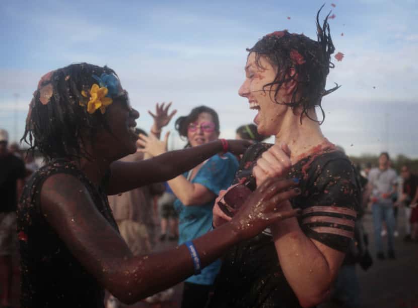 Shanita Mims embraces her friend Ladessa Jones during a tomato battle at theTexas State...