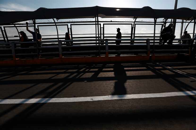 Un grupo de personas regresa a pie a Ciudad Juárez, México, por el puente Paso del Norte,...