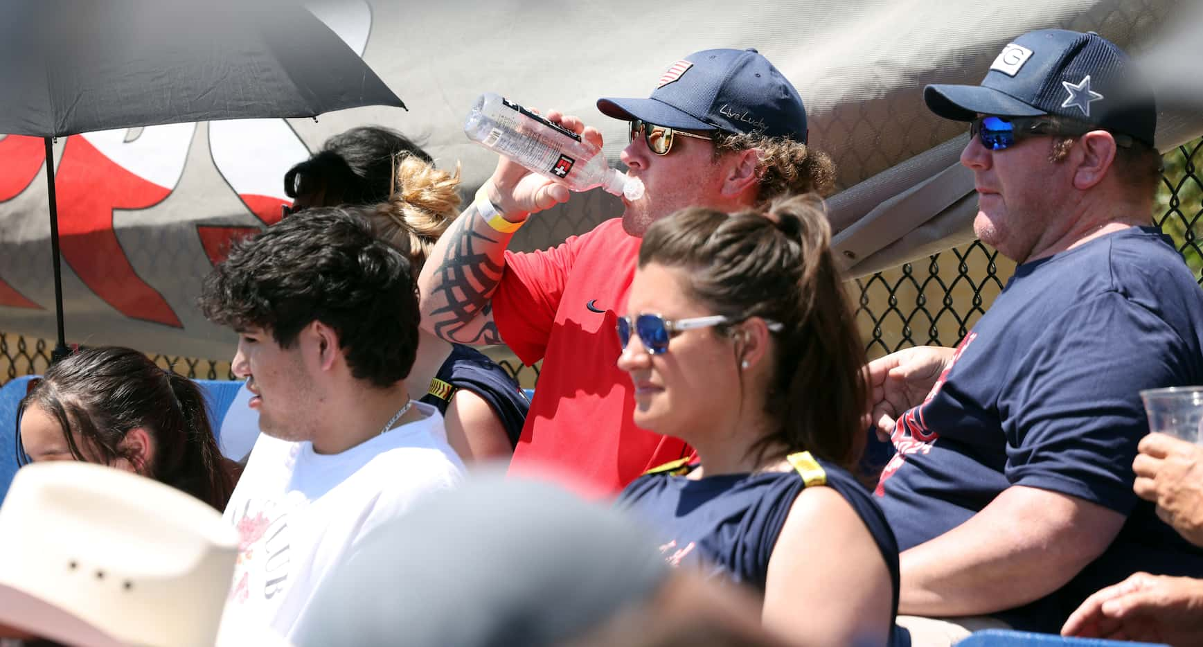 Former Texas Rangers outfielder Josh Hamilton, upper center, hydrates during the 4th inning...