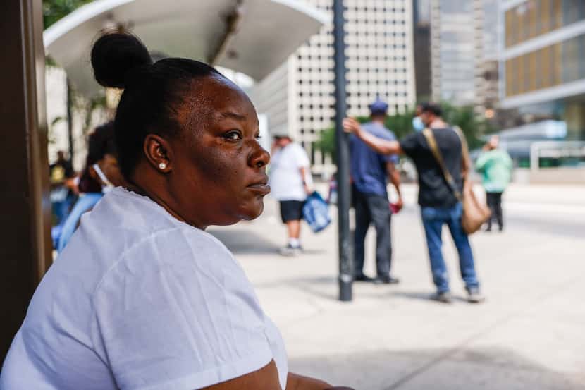 Arkenya Foggy waits for the 109 bus on Pacific Ave in Dallas on Thursday, June 23. 2022. The...