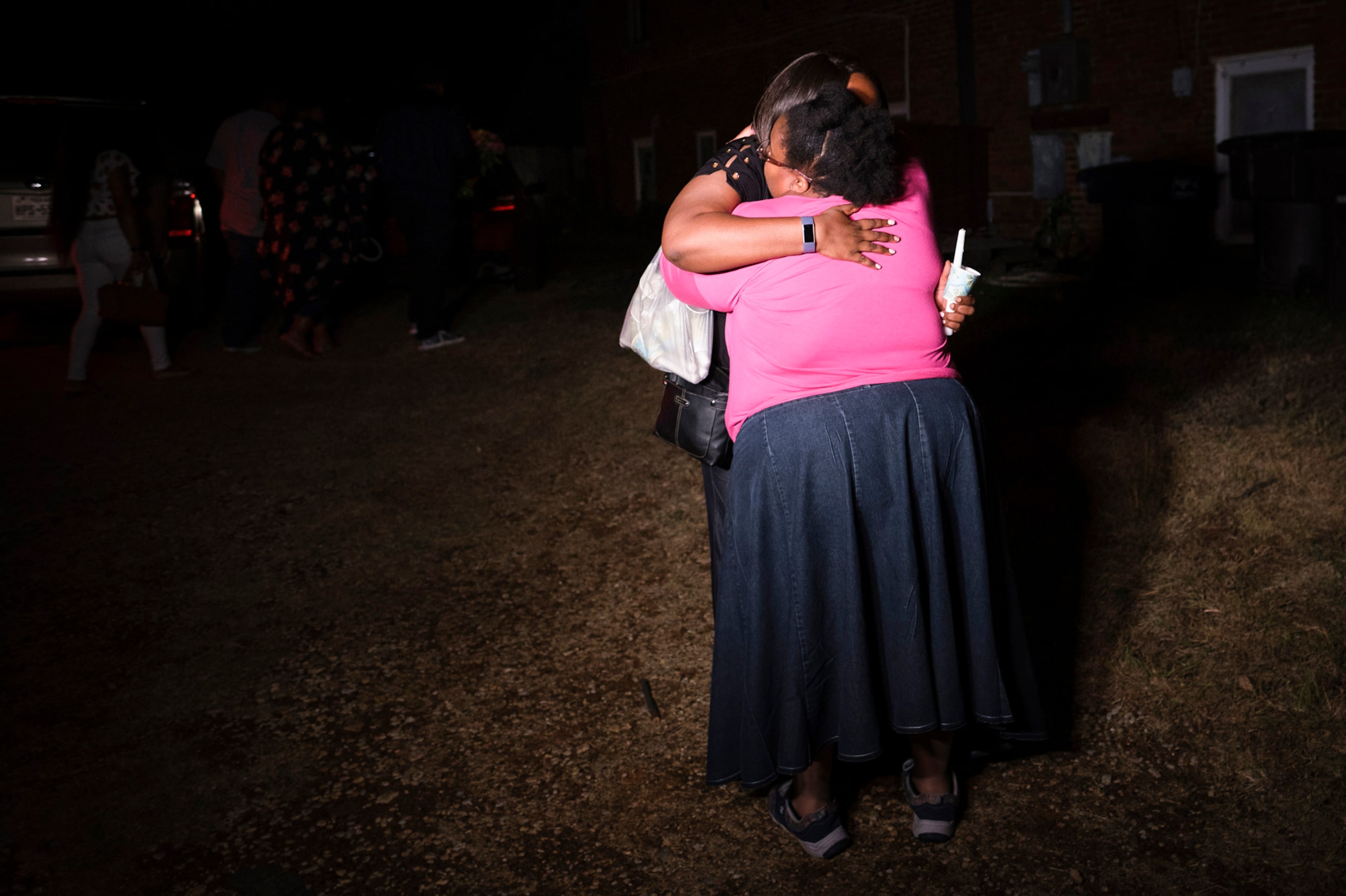 Members of the victimÕs family embrace as they depart a community vigil for Atatiana...