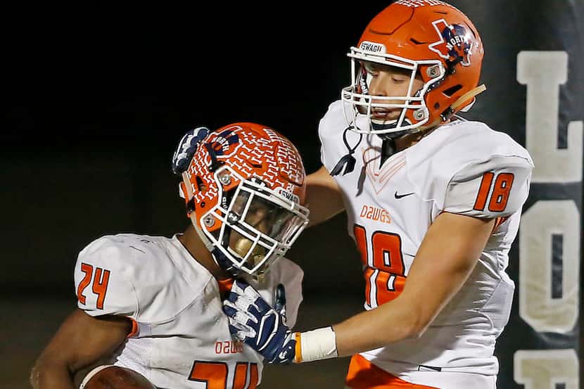 McKinney North's Lamar Lucas (left) is congratulated by teammate Parker Brehm after he...