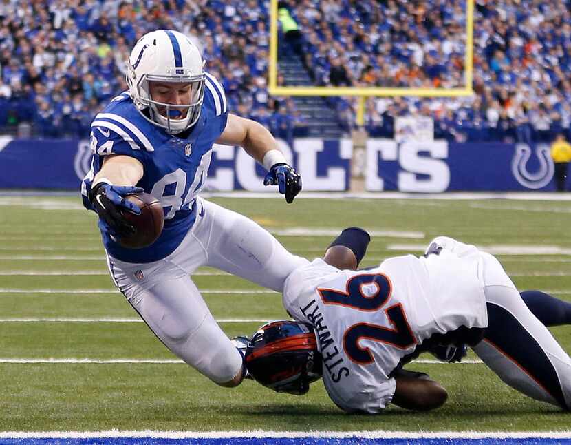 Indianapolis Colts' Jack Doyle (84) dives for a three yard touchdown reception while being...