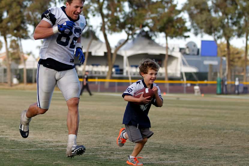 Dallas Cowboys tight end Jason Witten (82) plays football with his son Cooper Witten, 5...