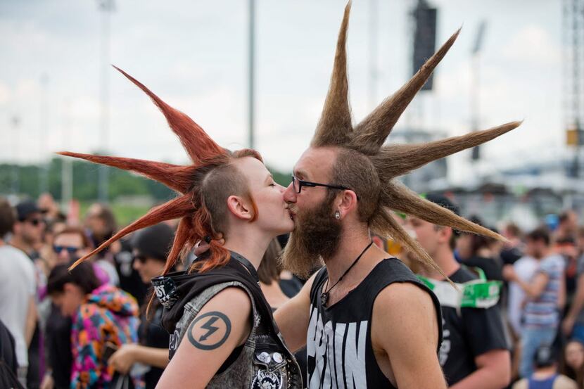 A couple with mohican styled hair kiss on June 5, 2016 at the Rock im Park music festival in...
