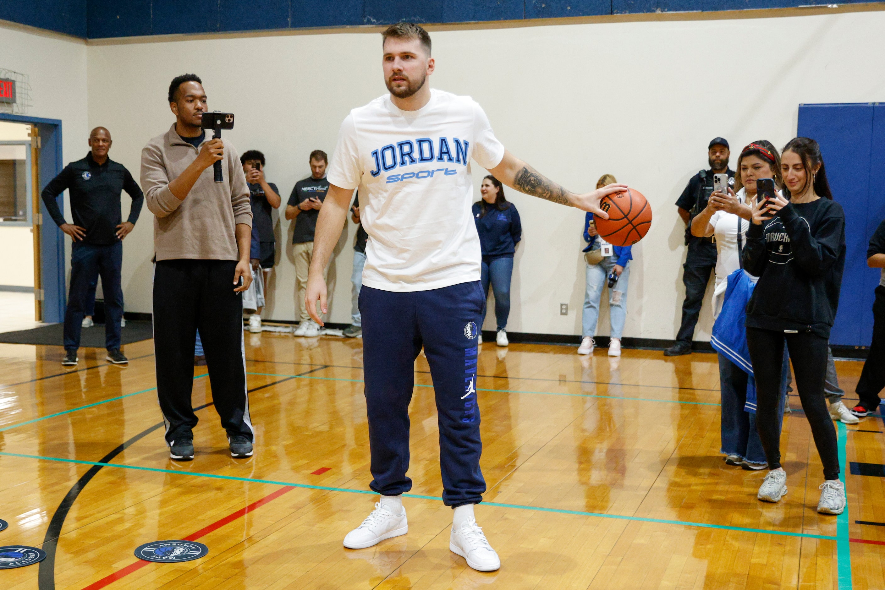 Dallas Mavericks guard Luka Doncic dribbles a basketball during a children’s basketball...