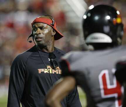 Deion Sanders communicates with his players during a game between Prime Prep Academy and...
