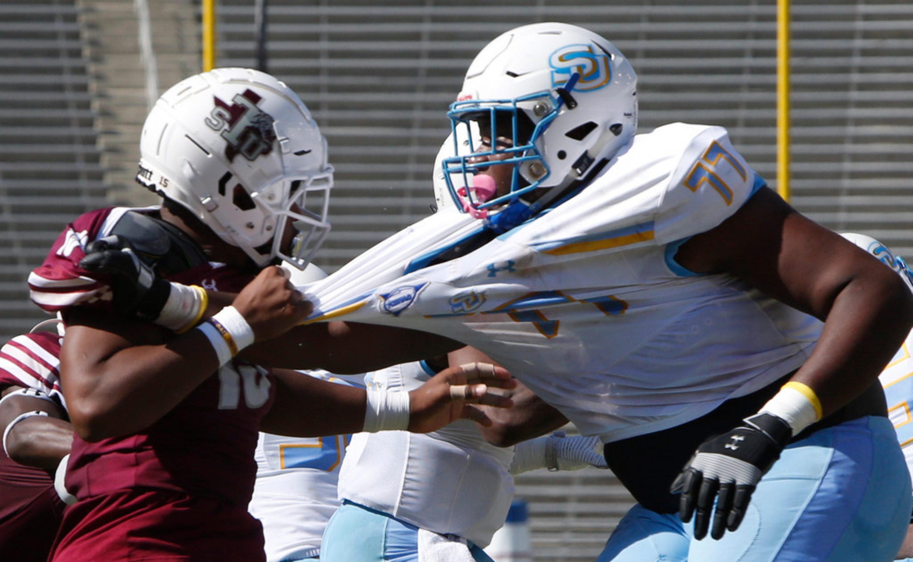 Texas State linebacker Tim Walton, Jr. (15) grabs a handful of Southern offensive lineman...