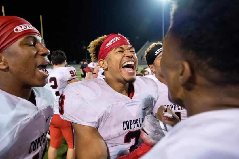 Coppell's Jonathan McGill (3) and KJ Liggins (11) celebrate their team's district...