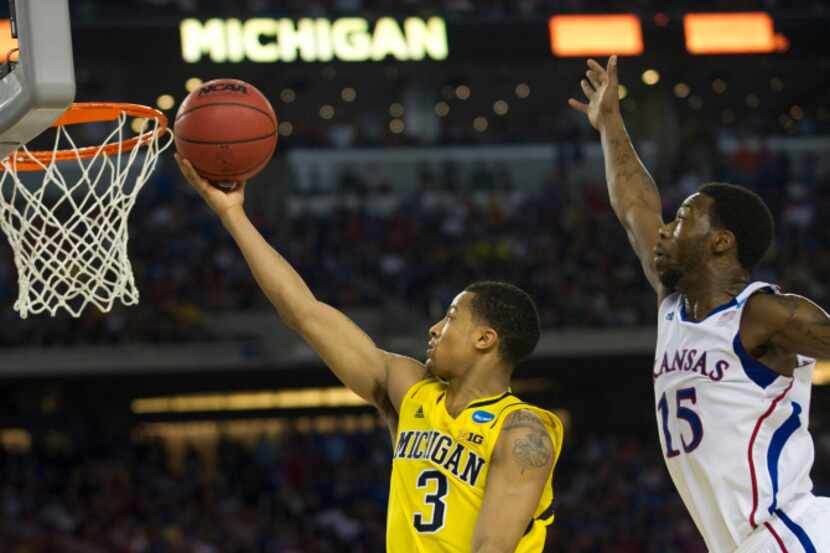 Trey Burke (3) of the University of Michigan Wolverines drives to the basket against the...