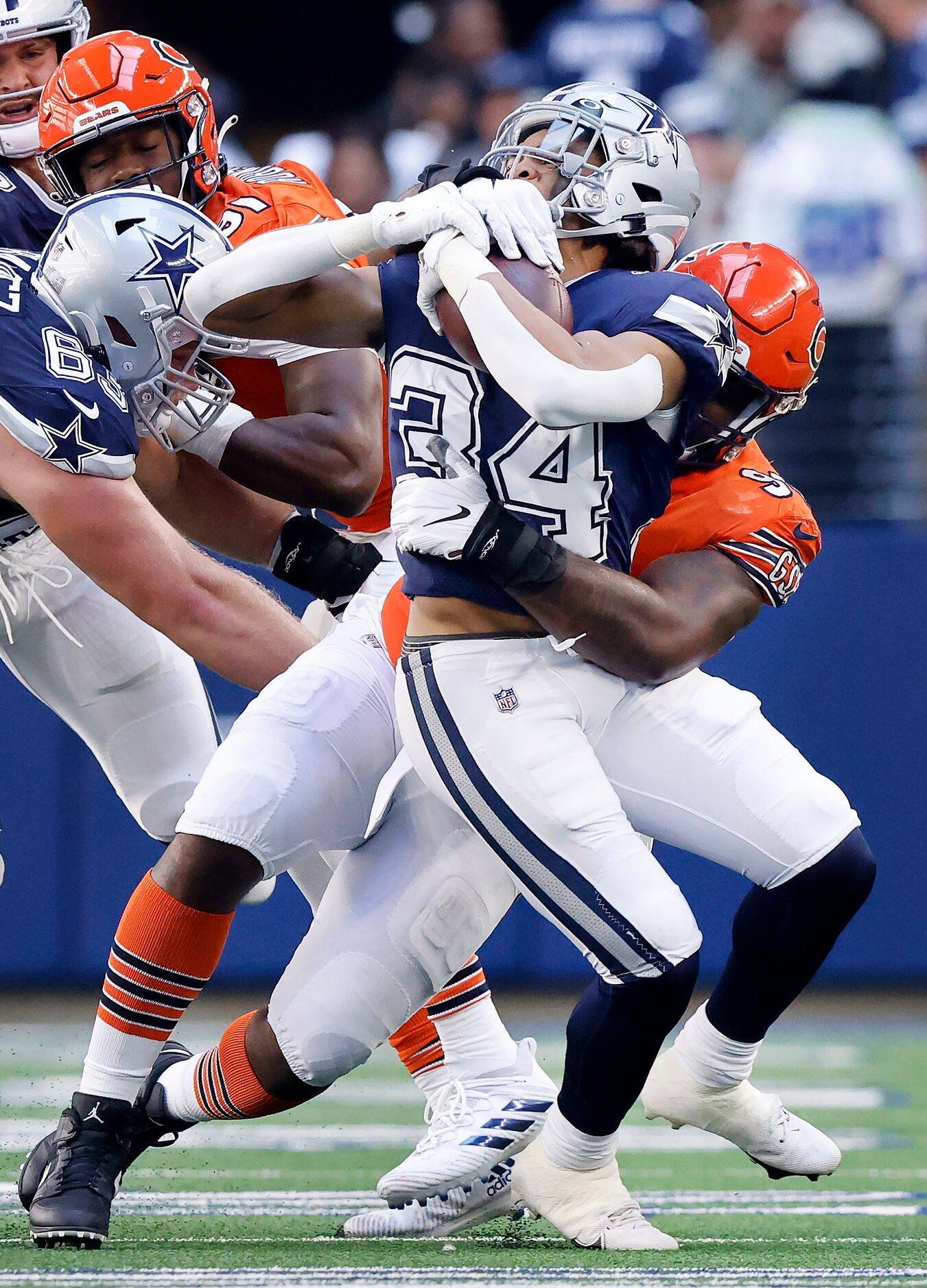 Dallas Cowboys running back Malik Davis (34) is wrapped up by Chicago Bears defensive tackle...