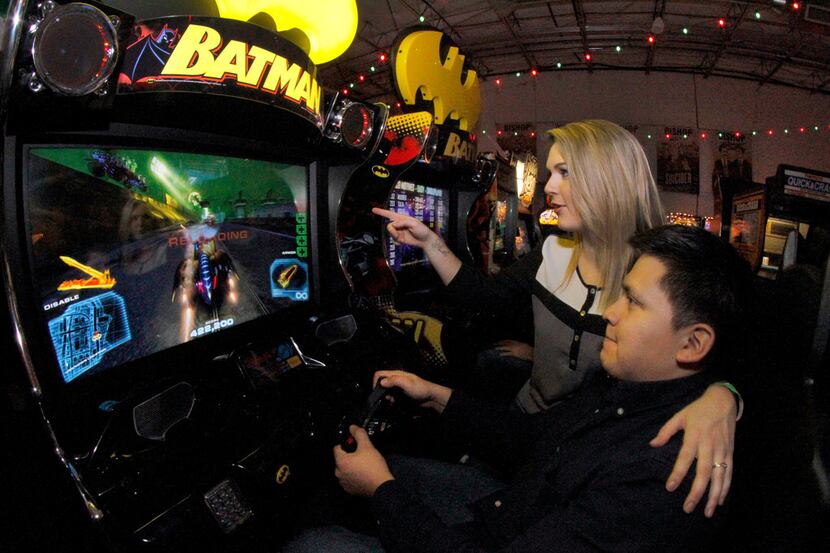 Tori VanBuskirk and Ruben Ortega maneuver through a Batman video game at Cidercade in...
