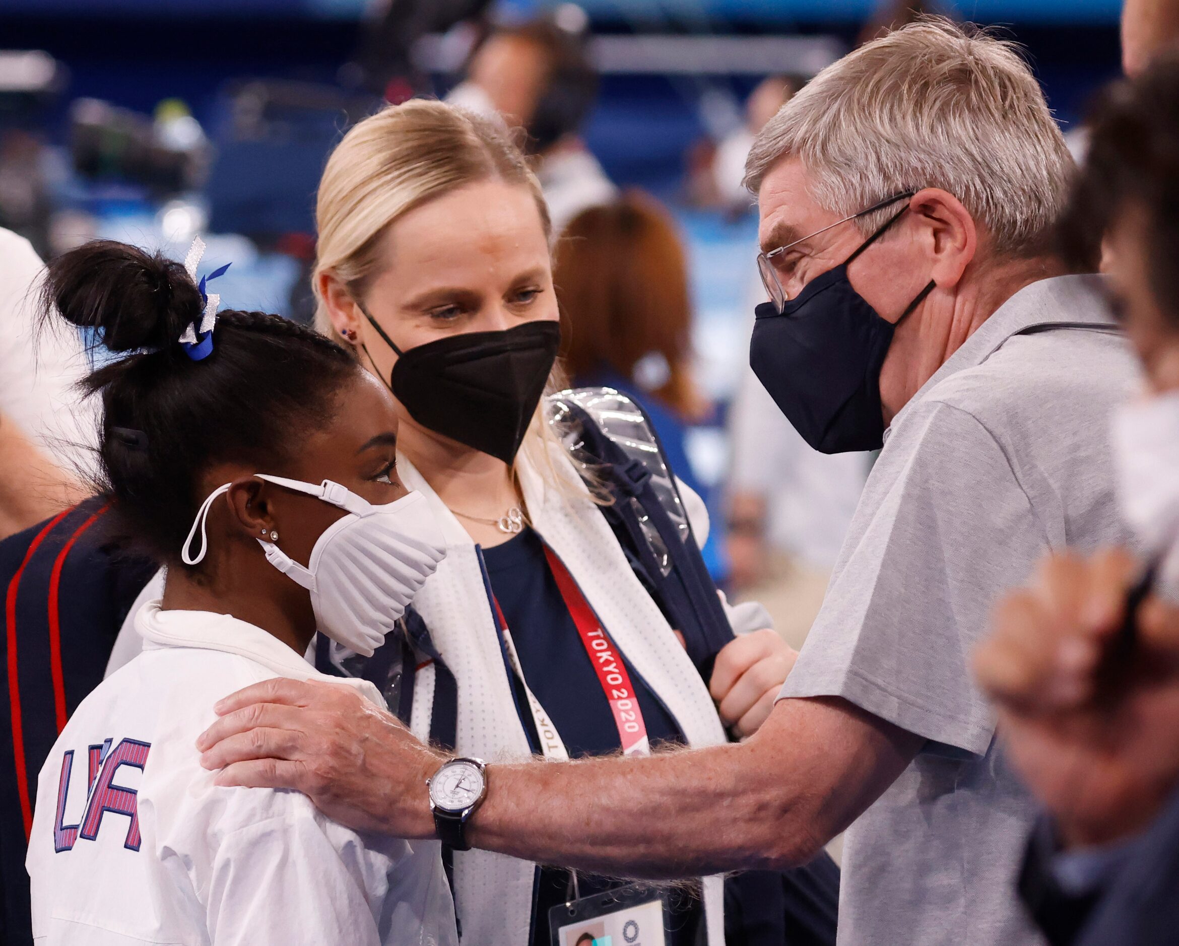 USA’s Simone Biles talks with IOC president Thomas Bach as she makes her way to the medal...