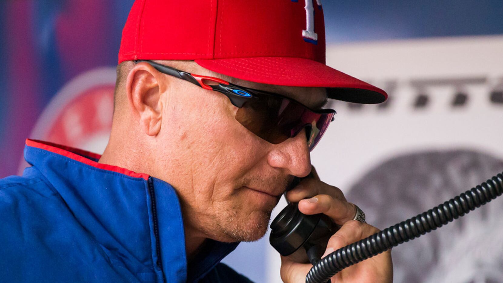 Texas Rangers manager Jeff Banister makes a call to the bullpen before replacing relief...