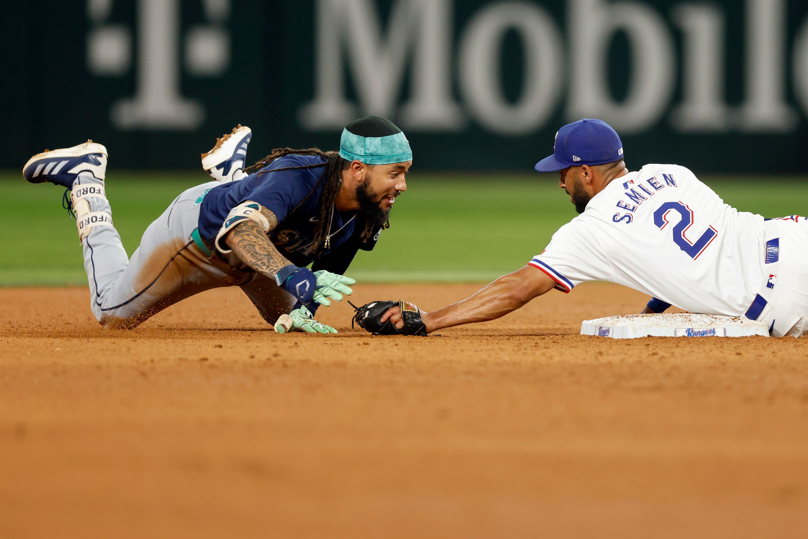 Texas Rangers second baseman Marcus Semien (2) tags out Seattle Mariners shortstop J.P....