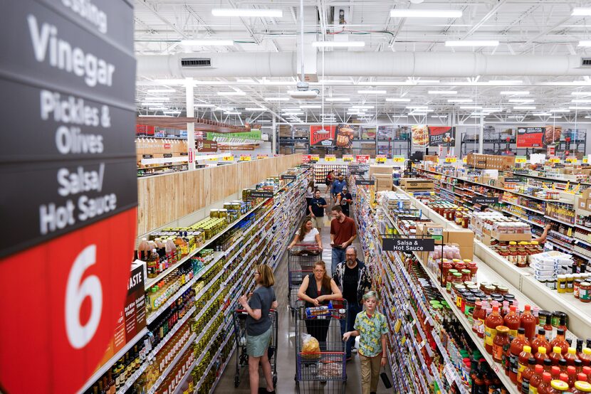 Customers shop around during the opening day of H-E-B on Wednesday, July 19, 2023, in...