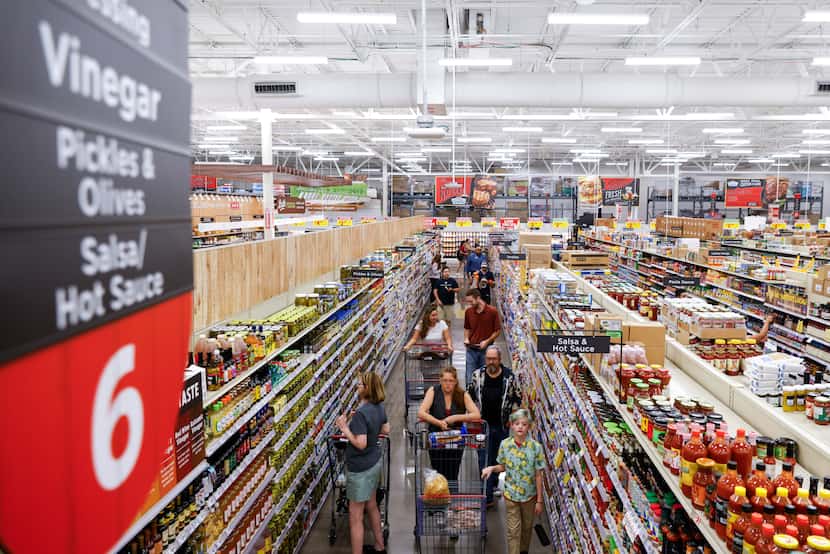 Customers shop around during the opening day of H-E-B on Wednesday, July 19, 2023, in...