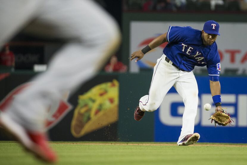 Texas Rangers shortstop Elvis Andrus fields a ground ball off the bat of Los Angeles Angels...