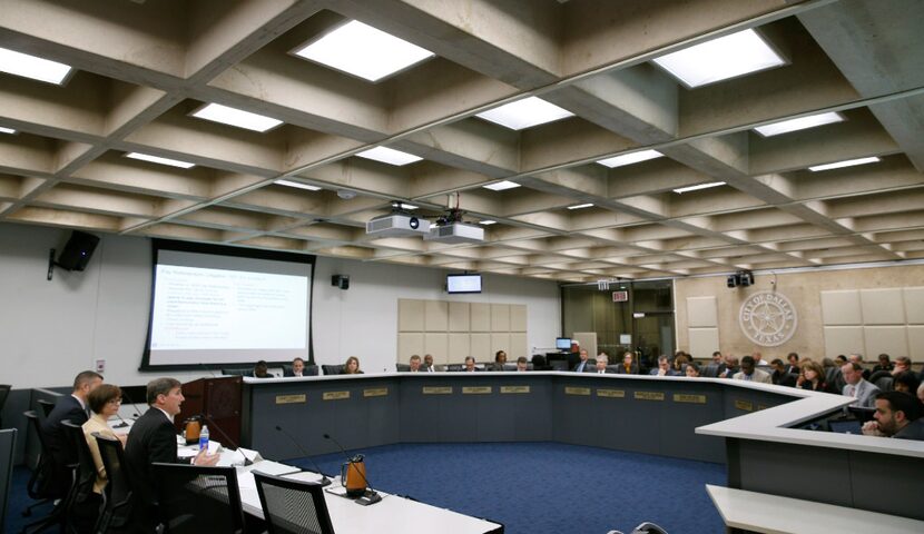 Larry Casto (left seated), city attorney, gives a report of the standing on plans for the...