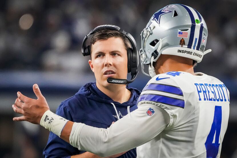 Dallas Cowboys offensive coordinator Kellen Moore talks with quarterback Dak Prescott during...
