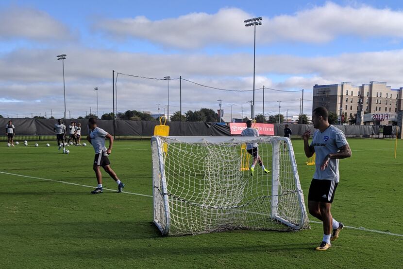 Fabian Bazan conducts a drill early in FC Dallas' training. Marcos Pedroso has just finished...