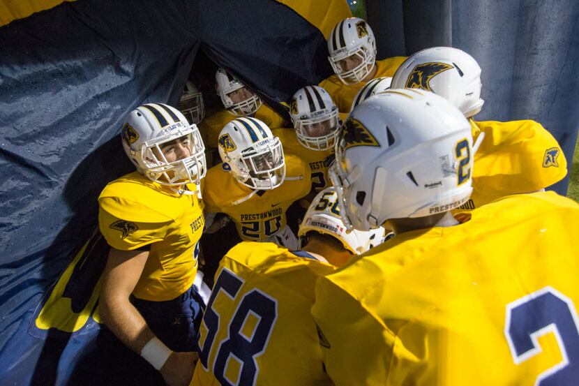 Prestonwood Lions players celebrate in the tunnel before the football game between...
