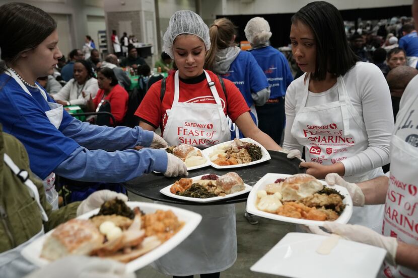WASHINGTON, DC - NOVEMBER 21:  Volunteers serve Thanksgiving meals during the annual Safeway...