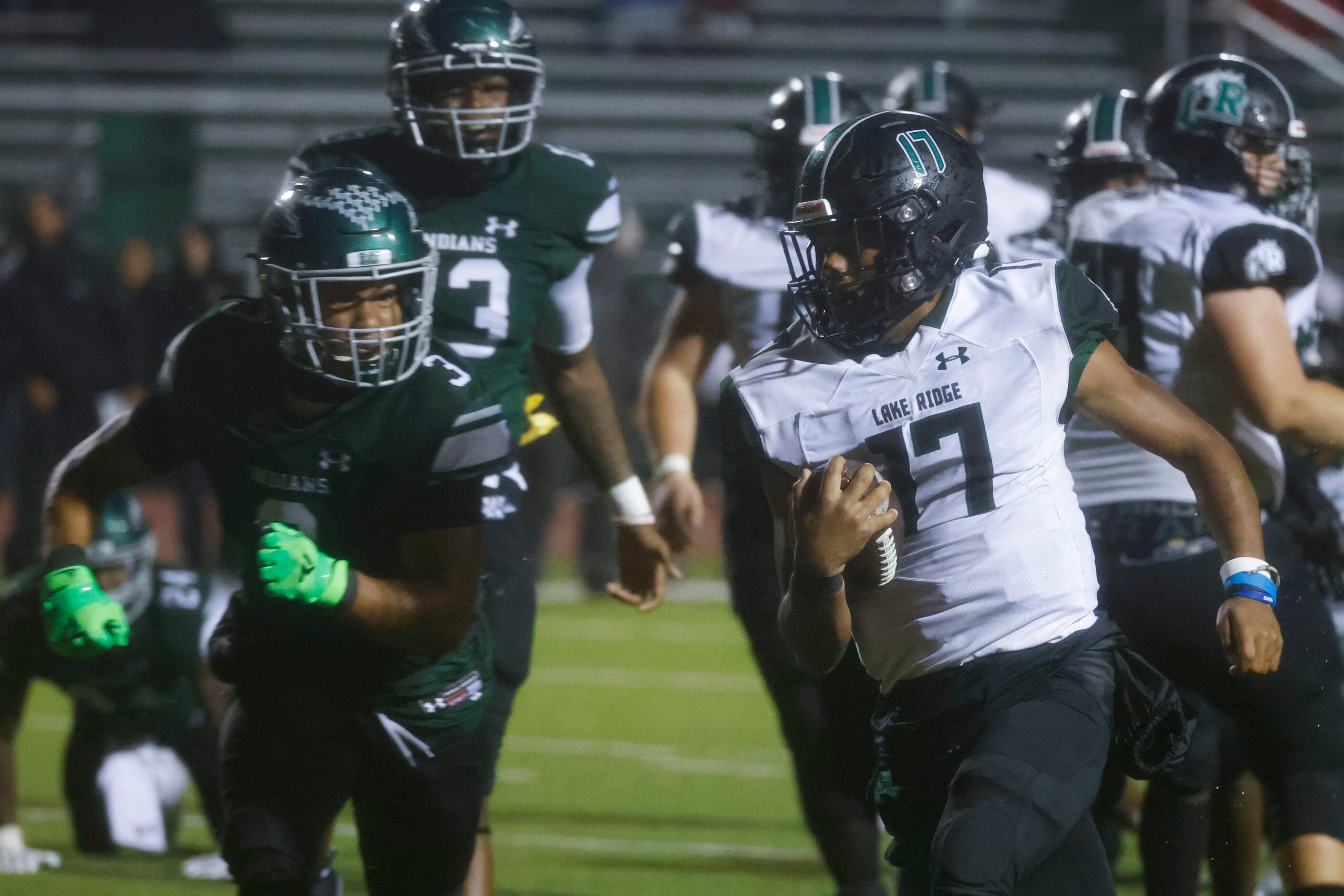 Mansfield Lake Ridge high’s Kennen Miller (17), right, runs past Waxahachie’s Gregory Hatley...