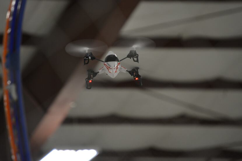 A drone files through the last obstacle while racing in amateur races in hangar 4 at the...