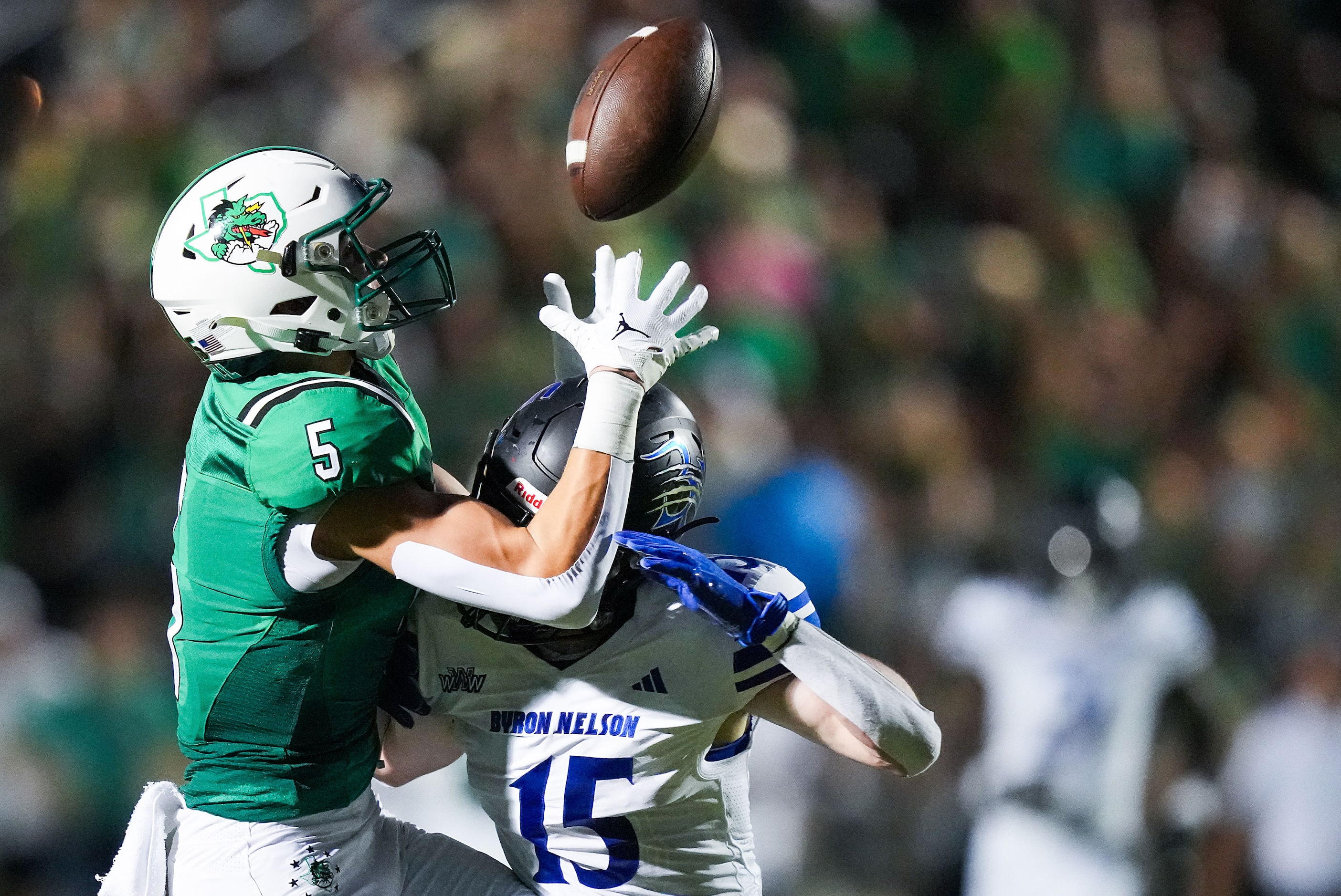 Trophy Club Byron Nelson’s  Dylan Kelly (15) breaks up a pass intended for Southlake Carroll...