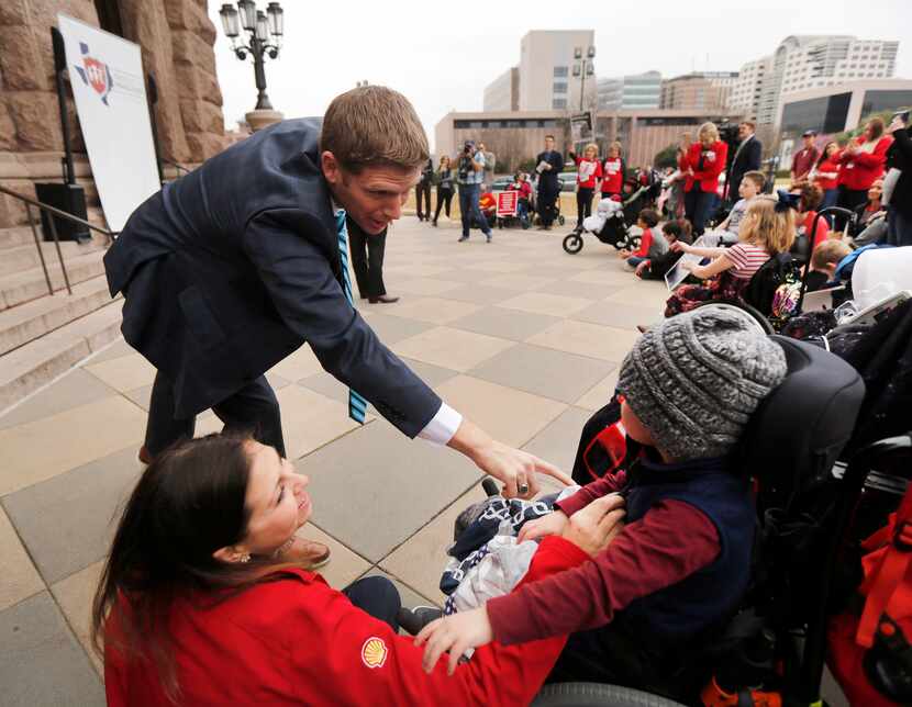 Rep. Matt Krause, R-Tarrant County (left) visits with Beckham Sheiman, 3, and her mother...