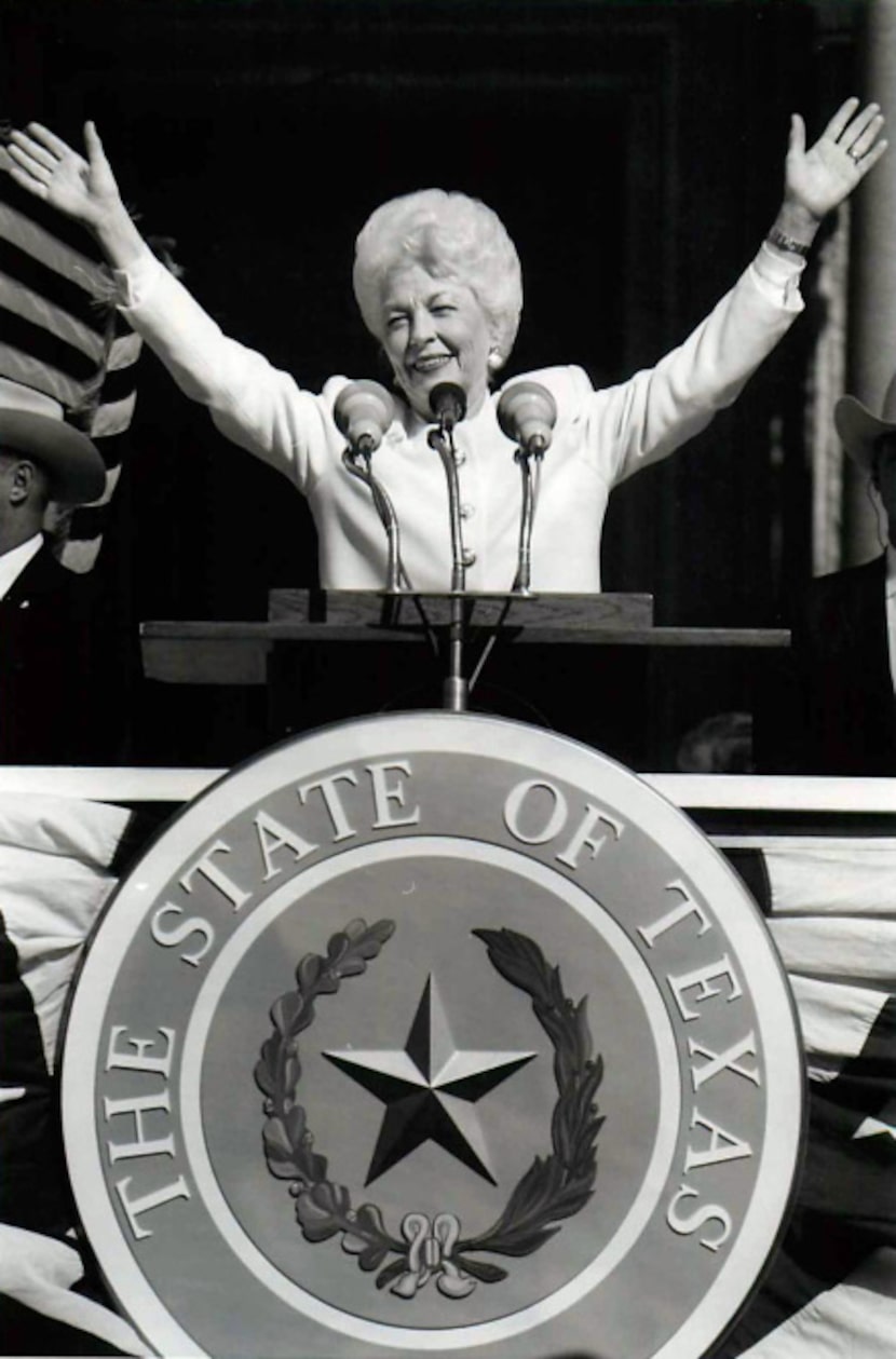 Richards waves to the cheering crowd after being sworn in on the south steps of the Capitol...