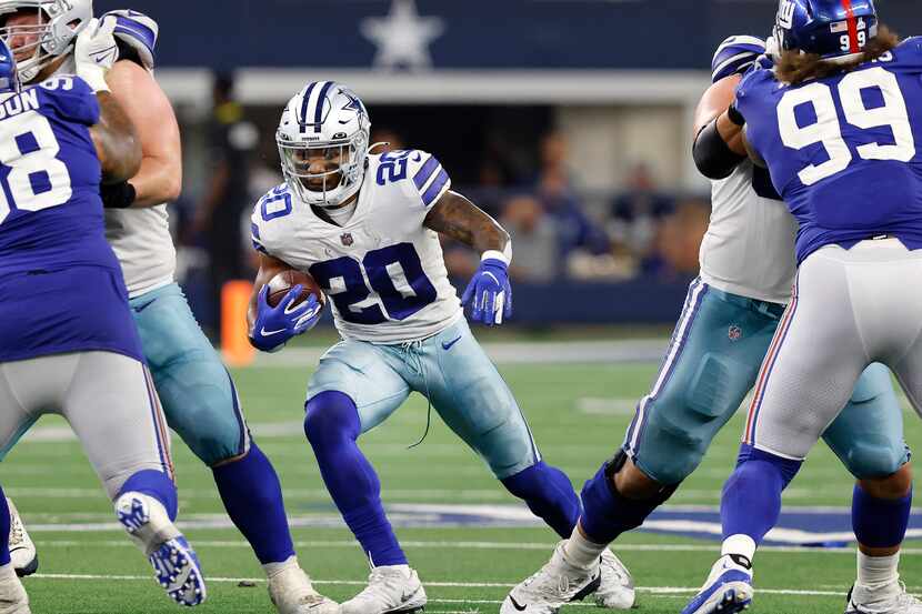 Dallas Cowboys running back Tony Pollard (20) looks for a hole in the offensive line during...