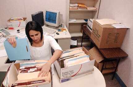 Elsa Garcia Jaime goes through student records from Lynacre Academy after the South Dallas...