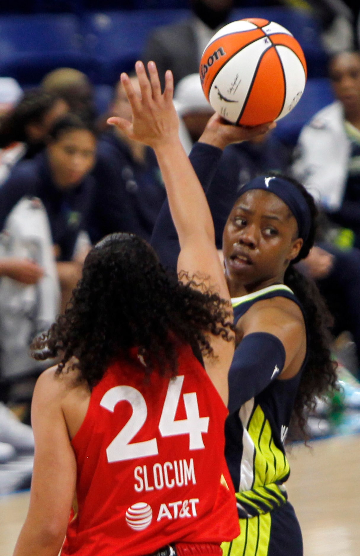 Dallas Wings guard Arike Ogunbowale (24) looks to pass around the defense of Las Vegas guard...