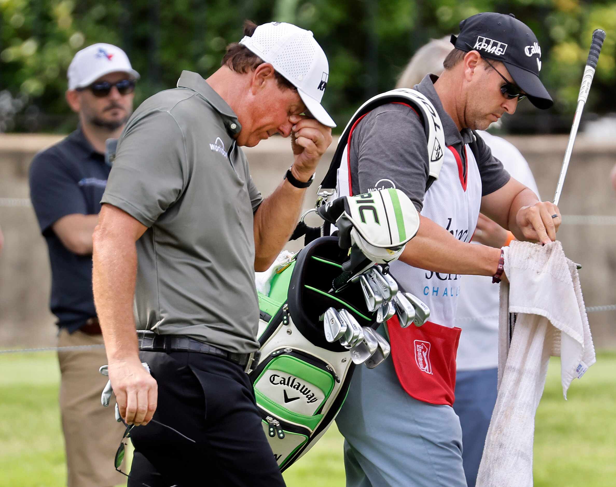 Professional golfer Phil Mickelson reacts after hitting his chip shot into the green side...