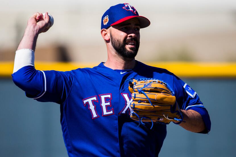 Texas Rangers starting pitcher Dillon Gee (36) throws to first base during a workout at the...