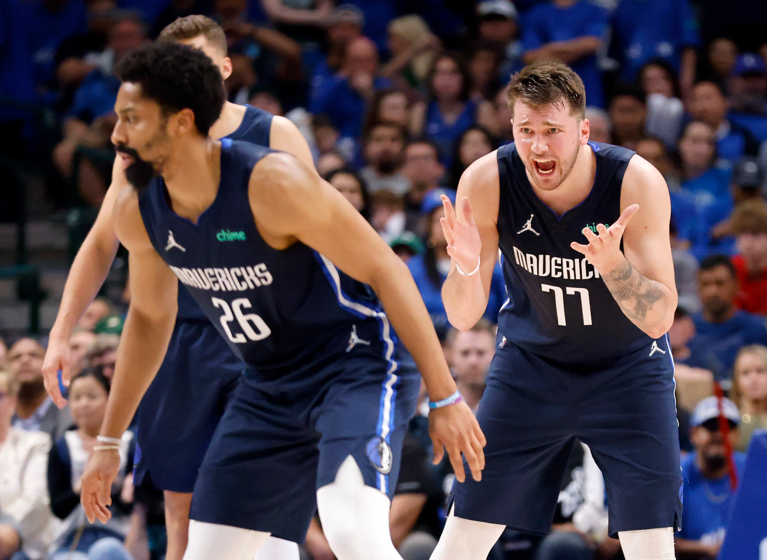 Dallas Mavericks guard Luka Doncic (77) yells at guard Spencer Dinwiddie (26) during the...