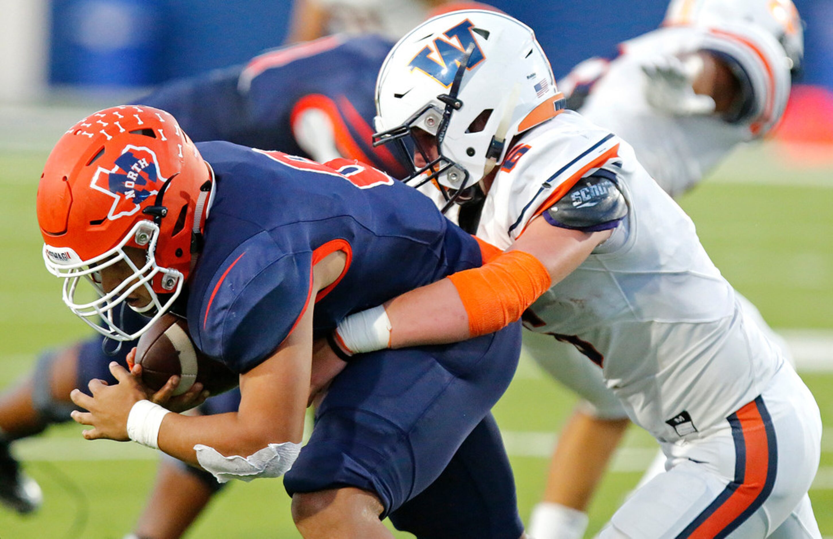 McKinney North High School running back Emmanuel Fincher (6) is tackled by Wakeland High...